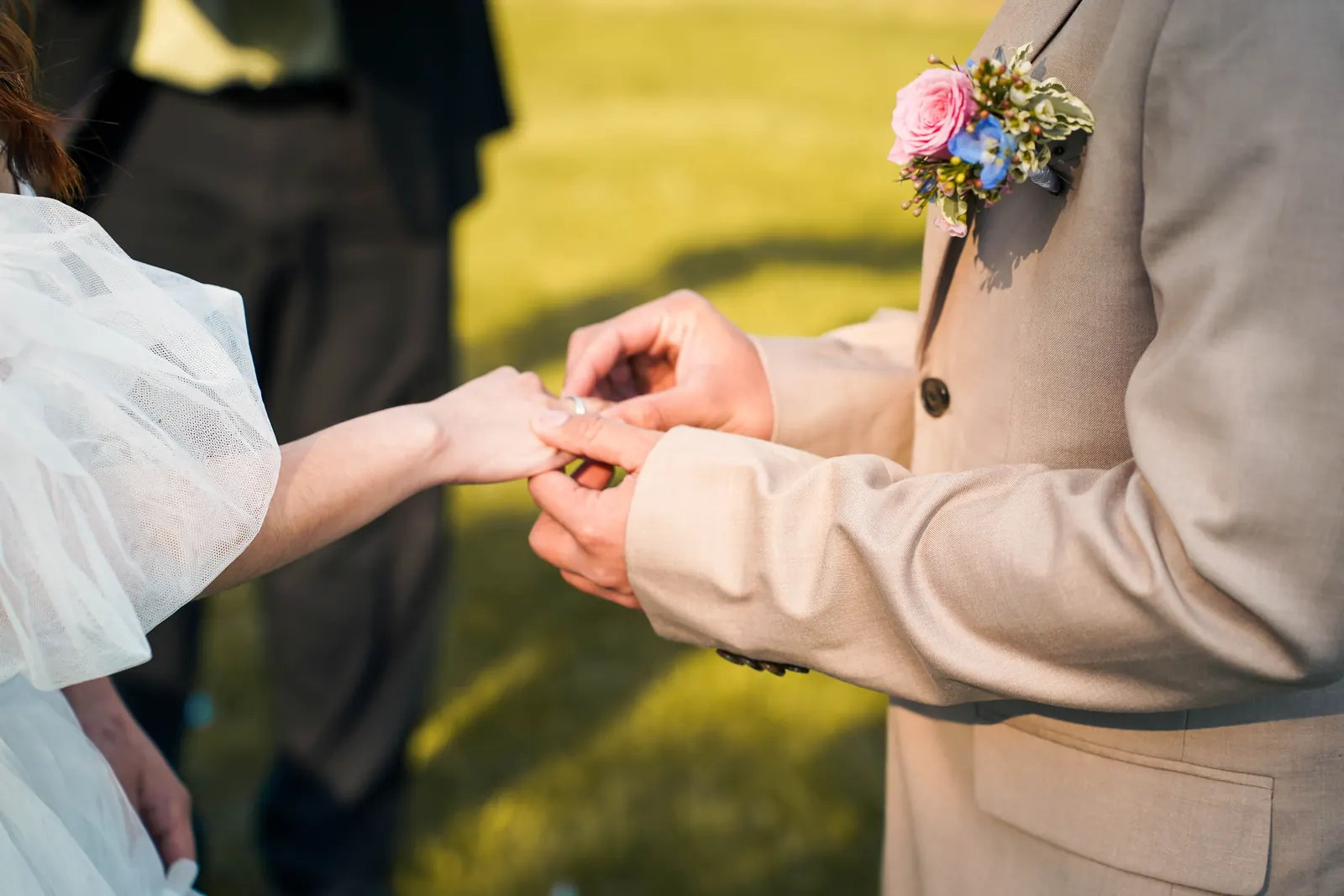 Bride and groom exchanging vows under a flower arch at a Windsor area wedding